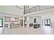 Spacious open-concept living space with a kitchen island, fireplace, and multiple windows overlooking trees at 2346 East Maddox Rd, Buford, GA 30518
