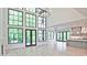 Bright living space featuring tall windows, gas fireplace, open concept kitchen, and modern fixtures at 2346 East Maddox Rd, Buford, GA 30518