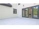 Outdoor patio features gray tile and a view into the living room with sliding doors at 2346 East Maddox Rd, Buford, GA 30518
