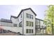 A spacious home with a white brick exterior, multiple windows, and a second-story balcony at 2346 East Maddox Rd, Buford, GA 30518