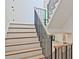 Elegant staircase features a light wood treads, white risers, and black iron railings, creating a modern, stylish look at 2346 East Maddox Rd, Buford, GA 30518