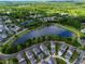 Aerial view of the community featuring a lake surrounded by lush trees and walking trails at 7455 Cordery Rd, Cumming, GA 30040
