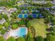 Aerial view of the community showcasing tennis courts, a pool, and lush landscaping at 7455 Cordery Rd, Cumming, GA 30040
