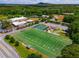 Aerial view of a sports complex with well-maintained fields, tennis courts, and surrounding amenities at 7455 Cordery Rd, Cumming, GA 30040