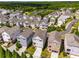 A beautiful aerial view of the neighborhood showcasing various home styles and a tranquil pond at 7455 Cordery Rd, Cumming, GA 30040