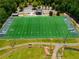 Aerial view of a well-maintained football field, complete with yard lines, goalposts, and surrounding facilities at 7455 Cordery Rd, Cumming, GA 30040