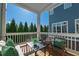 Relaxing back porch with comfortable seating and a serene view of lush green trees at 7455 Cordery Rd, Cumming, GA 30040