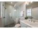 Modern bathroom featuring a glass-enclosed shower, a white vanity, and sleek fixtures at 7455 Cordery Rd, Cumming, GA 30040