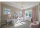 Cozy bedroom with white furniture, pink curtains, and a chandelier at 7455 Cordery Rd, Cumming, GA 30040