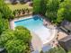 Aerial view of the neighborhood community pool with ample lounge chairs and beautiful trees at 7455 Cordery Rd, Cumming, GA 30040