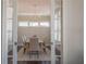Dining room with view through glass doors featuring stylish light fixture and seating at 7455 Cordery Rd, Cumming, GA 30040