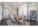 Bright dining room with a chandelier, neutral decor, and French doors at 7455 Cordery Rd, Cumming, GA 30040
