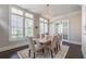 Inviting dining area with large windows, a stylish chandelier, and seating for six at 7455 Cordery Rd, Cumming, GA 30040