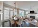 Elegant dining area features large windows, a modern chandelier, and flows into the living room at 7455 Cordery Rd, Cumming, GA 30040
