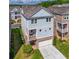 An aerial view of the house with a brick foundation, attached garage and a charming covered porch at 7455 Cordery Rd, Cumming, GA 30040