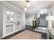 Elegant foyer with hardwood floors, stylish lighting, staircase, and decorative accents at 7455 Cordery Rd, Cumming, GA 30040