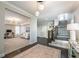 Elegant foyer with hardwood floors, stylish lighting, staircase, and opens to a living area at 7455 Cordery Rd, Cumming, GA 30040