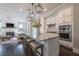 Beautiful kitchen with island, stainless steel appliances, and seating, open to the living room at 7455 Cordery Rd, Cumming, GA 30040