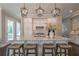 Spacious kitchen with a large island, granite countertops, stylish pendant lighting, and modern appliances at 7455 Cordery Rd, Cumming, GA 30040