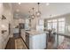 Bright, open kitchen features a large island, stainless steel appliances, and adjacent dining area at 7455 Cordery Rd, Cumming, GA 30040