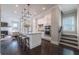 Open-concept kitchen with a large island, granite countertops, stylish lighting, and modern appliances at 7455 Cordery Rd, Cumming, GA 30040