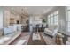 Open-concept living space with kitchen island, dining area, and comfortable seating at 7455 Cordery Rd, Cumming, GA 30040