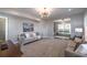 Open-concept living room with comfortable seating, modern decor, and seamless flow to other rooms at 7455 Cordery Rd, Cumming, GA 30040