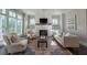 Cozy living room with a fireplace, white brick surround, and large windows at 7455 Cordery Rd, Cumming, GA 30040