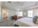 Spacious main bedroom with tray ceiling and ensuite bath featuring dual sinks and a tub at 7455 Cordery Rd, Cumming, GA 30040