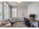 Bright home office with lots of natural light, hardwood floors, and comfortable seating at 7455 Cordery Rd, Cumming, GA 30040