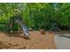 Community playground area with slides, climbing structures, and a wood chip surface at 7455 Cordery Rd, Cumming, GA 30040
