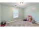 Bright bedroom with a window, soft carpet, and a playful toy corner at 1605 Barrier Rd, Marietta, GA 30066