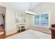 Dining room with modern light fixture, hardwood floors, and a large window at 1605 Barrier Rd, Marietta, GA 30066