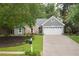Charming home featuring a combination of stone and siding, complemented by a two-car garage and a well-maintained front yard at 1605 Barrier Rd, Marietta, GA 30066