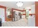 Modern kitchen with tile floors, stainless steel appliances, and a view into the adjacent living room at 1605 Barrier Rd, Marietta, GA 30066