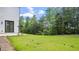Green grassy backyard with exterior patio and door to the home at 298 Tillman Pass, Woodstock, GA 30188