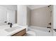Bathroom featuring a modern sink, faucet, and white tiled shower and bathtub at 298 Tillman Pass, Woodstock, GA 30188
