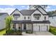 Beautiful two-story home featuring white brick, a dark gray roof, and a two-car garage at 298 Tillman Pass, Woodstock, GA 30188