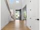 Bright foyer with hardwood floors, staircase, and clerestory windows providing abundant natural light at 298 Tillman Pass, Woodstock, GA 30188