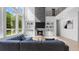 Spacious living room featuring built-in shelving, a fireplace, and large windows with views of the outdoors at 298 Tillman Pass, Woodstock, GA 30188