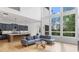 Open-concept living space with high ceilings, large windows, and a modern kitchen, perfect for entertaining at 298 Tillman Pass, Woodstock, GA 30188
