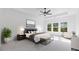 Serene main bedroom with trey ceiling, a ceiling fan, plush carpeting, and large windows with a view of trees at 298 Tillman Pass, Woodstock, GA 30188