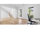 Office featuring white walls, hardwood floors, natural light, and a modern desk set up. Ideal for remote work at 298 Tillman Pass, Woodstock, GA 30188