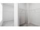 Spacious walk-in closet with built-in wire shelving and neutral carpeting for optimal storage at 298 Tillman Pass, Woodstock, GA 30188