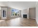 Bright living room with hardwood floors, a fireplace, large windows, and neutral paint at 313 Sassafras Way, Holly Springs, GA 30115