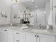 Bright bathroom with a large mirror reflecting double sinks and white cabinets at 3408 Landen Pine Ne Ct, Atlanta, GA 30305