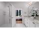 Bright bathroom featuring dual sinks, walk-in shower, and a view into an adjacent bedroom at 3408 Landen Pine Ne Ct, Atlanta, GA 30305