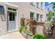 Inviting front entrance with garden bed and statues leading to a painted door and brick wall at 3408 Landen Pine Ne Ct, Atlanta, GA 30305