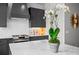 Modern kitchen with gray cabinets, stainless steel appliances, and marble countertops at 3408 Landen Pine Ne Ct, Atlanta, GA 30305