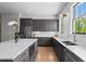 Spacious kitchen with gray cabinets, marble countertops, and stainless steel appliances at 3408 Landen Pine Ne Ct, Atlanta, GA 30305